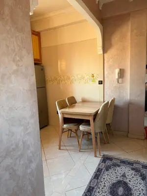 a dining room with a wooden table and chairs at Julie's Private Apartment in Marrakech