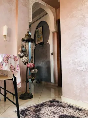 a hallway with an archway and a room with a rug at Julie's Private Apartment in Marrakech