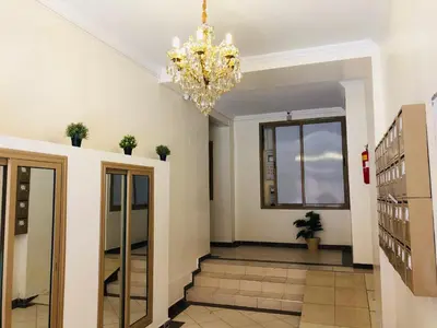 a hallway with a chandelier in a building at Julie's Private Apartment in Marrakech