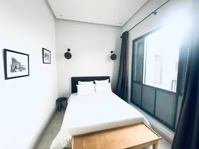 a small bedroom with a bed and a window at AZ RIAD in Marrakech