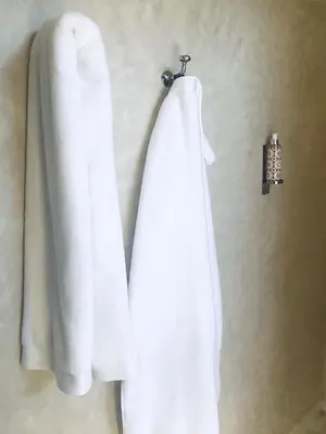 a pair of white towels hanging on a wall at AZ RIAD in Marrakech