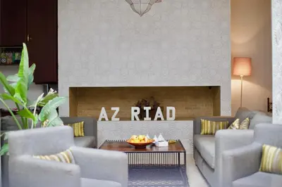 a living room with couches and a fire place at AZ RIAD in Marrakech