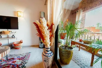 a living room with two large vases with plants in it at Majorelle Garden Retreat 2BR Apartment Near Jardin Majorelle in Marrakech
