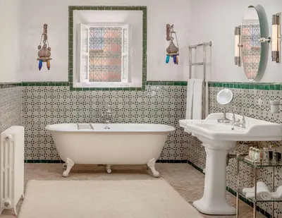 a bathroom with a tub and a sink at Riad L'Hôtel Marrakech in Marrakech