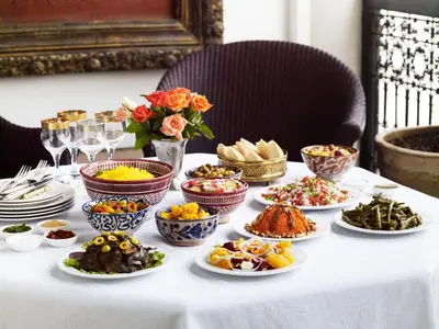 a table with many plates of food on it at Riad L'Hôtel Marrakech in Marrakech