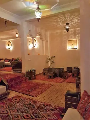 a large room with chairs and tables in a building at Riad Al Jawhar in Marrakech