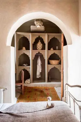 a bedroom with an archway with a bed in it at Riad KHOL Bohémia in Marrakech