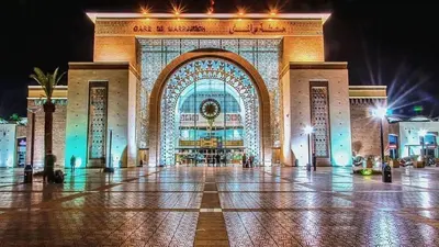 a large building with a lit up facade at night at Superbe appartement Hivernage in Marrakech