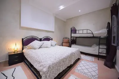 a bedroom with a bed and two bunk beds at 