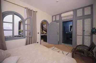 a bedroom with a bed and a window and a desk at 