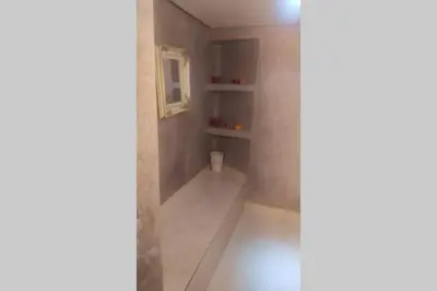 a small bathroom with a shower with a shelf at Magnifique villa avec piscine chauffée que pour famille in Marrakech