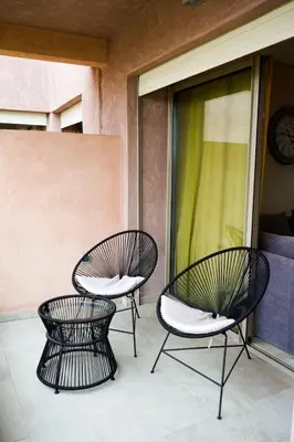 a couple of chairs sitting on a balcony at Prestigia Golf City Marrakech in Marrakech