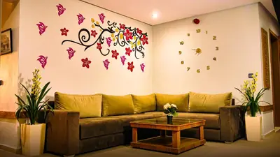 a living room with a couch and butterflies on the wall at EL MOUSSAFIR HOTEL in Marrakech