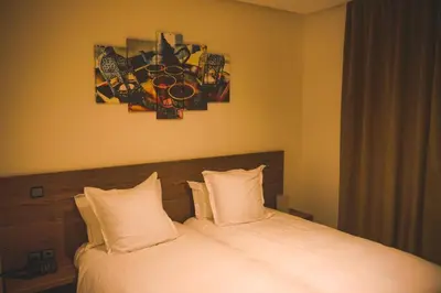 a bedroom with a bed with two pillows at EL MOUSSAFIR HOTEL in Marrakech