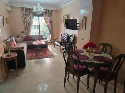 a living room with a table and a couch at Luxury apartment in the heart of Gueliz , Wifi, Pool in Marrakech