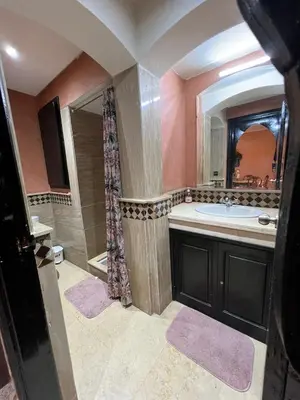 a bathroom with a sink and a shower and a mirror at Luxury apartment in the heart of Gueliz , Wifi, Pool in Marrakech