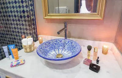 a bathroom sink with a blue and white bowl at dar al walidine in Marrakech