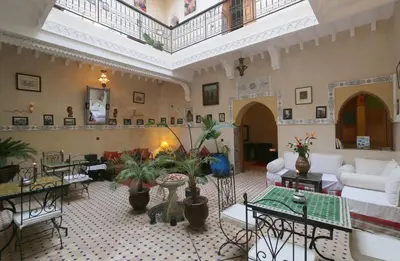 a large living room with furniture and plants in it at Riad Maissoun in Marrakech