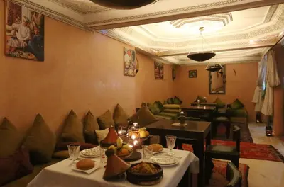 a dining room with a table with food on it at Riad Maissoun in Marrakech