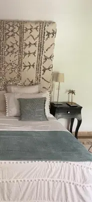 a bedroom with a bed and a table with a lamp at Riad Timila in Marrakech