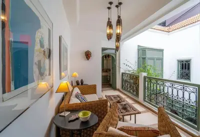 a living room with a couch and a table at Riad Timila in Marrakech