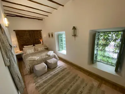 a bedroom with a bed and a large window at Riad Timila in Marrakech
