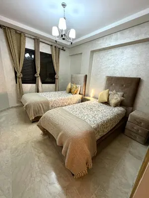 a bedroom with two beds and a window at Duplex Sabah Opera - Quartier Hivernage in Marrakech