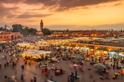 a crowd of people walking around a market at sunset at Pestana CR7 Marrakech in Marrakech