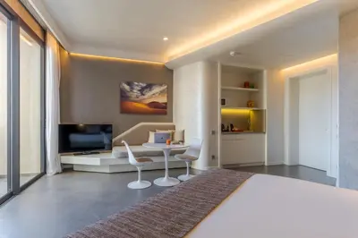 a bedroom with a bed and a desk and a tv at Pestana CR7 Marrakech in Marrakech