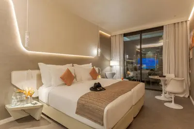 a bedroom with a bed with a cat sitting on it at Pestana CR7 Marrakech in Marrakech