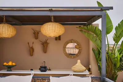 a kitchen with rattan lights and a mirror at Riad Algora en exclusivité 13 P au cœur de la Médina in Marrakech