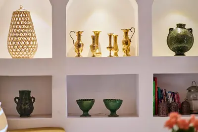 a row of vases and other items on shelves at Riad Algora en exclusivité 13 P au cœur de la Médina in Marrakech