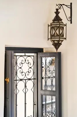 a lamp hanging above a door and a window at Riad Algora en exclusivité 13 P au cœur de la Médina in Marrakech