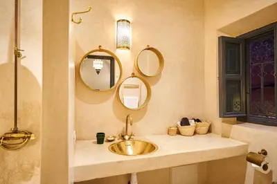 a bathroom with a sink and mirrors on the wall at Riad Algora en exclusivité 13 P au cœur de la Médina in Marrakech