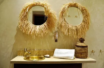 a bathroom with a sink and two mirrors on the wall at Riad l'Escale de Marrakech in Marrakech