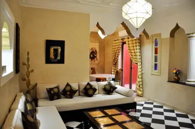 a living room with a couch and a checkered floor at Riad l'Escale de Marrakech in Marrakech