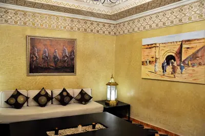 a room with a painting on the wall and a couch at Riad l'Escale de Marrakech in Marrakech