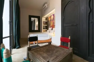a bedroom with a bed and a large window at Riad Touareg in Marrakech