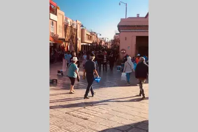 a group of people walking down a street at Riad Touareg in Marrakech