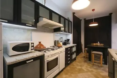 a kitchen with a microwave and a stove top oven at Riad Touareg in Marrakech