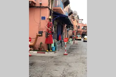 a street with a statue on the side of a building at Riad Touareg in Marrakech