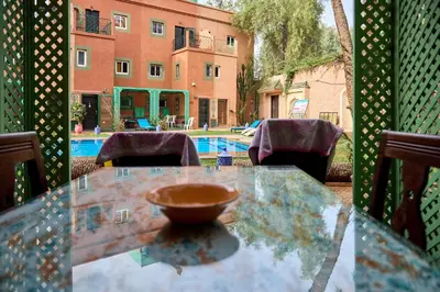 a glass table with a bowl sitting on top of it at Riad AMBER ZAHRA in Marrakech