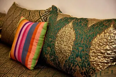 a couple of pillows sitting on a couch at Riad AMBER ZAHRA in Marrakech