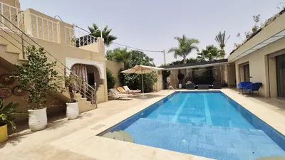 a swimming pool in the backyard of a house at Le clos des oliviers de Marrakech in Marrakech
