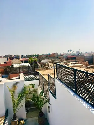 a balcony of a building with palm trees on it at Riad Olika in Marrakech