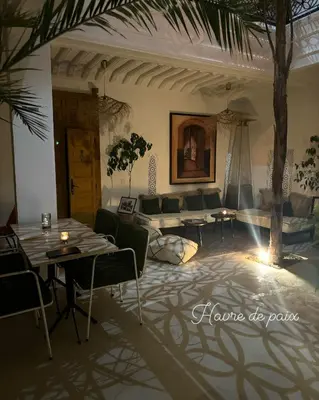 a living room with a couch and a table at Riad Olika in Marrakech