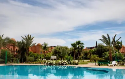 a swimming pool at a resort with palm trees at Duplex Atlas Golf Resort Pοοl νieω Seriniτყ & Cαlm in Marrakech