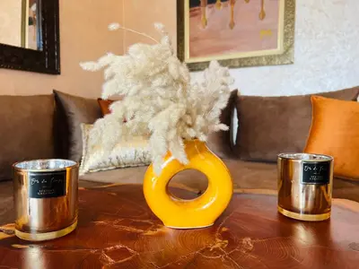a table with a yellow vase on a table at Duplex Atlas Golf Resort Pοοl νieω Seriniτყ & Cαlm in Marrakech