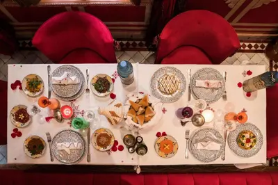a table with plates of food on it at Riad Hikaya in Marrakech