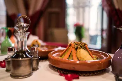 a table with a plate of food on a table at Riad Hikaya in Marrakech